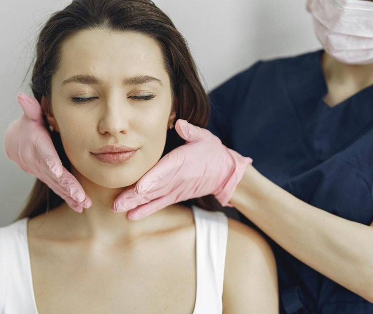 Aesthetician provides a relaxing facial treatment to a woman in a spa, enhancing her beauty and skincare routine.